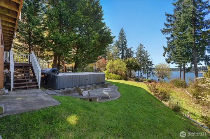 Waterfront lawn and patio area with swim spa and beautiful Eld Inlet views. Waterfront lawn and patio area with swim spa and beautiful Eld Inlet views.