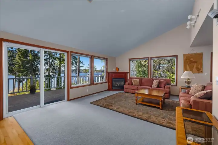 Living room features expansive windows, fireplace, and direct access to the view deck. Living room features expansive windows, fireplace, and direct access to the view deck.