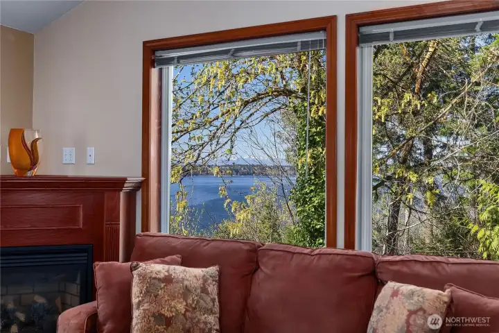 Water views framed by large picture windows bring the outdoors into the living room. Water views framed by large picture windows bring the outdoors into the living room.