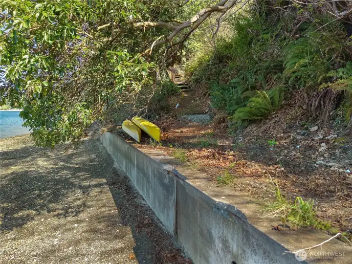 Bulkheaded shoreline with beach access path and room for kayaks or waterfront gear. Bulkheaded shoreline with beach access path and room for kayaks or waterfront gear.