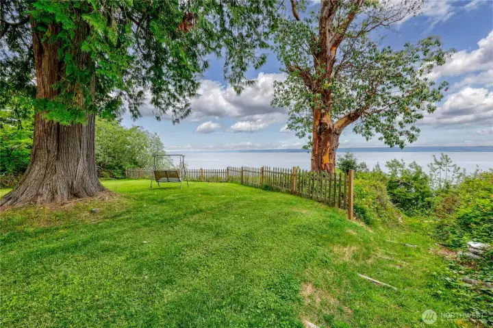 Partially fenced at the top of the yard.