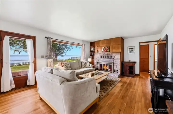 A room with a view. Note the beautiful oak floors and cheery wood burning fire place.