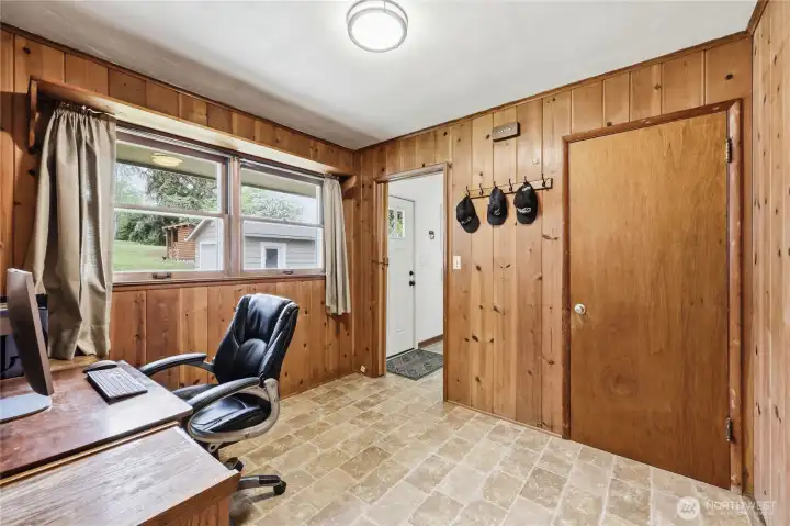 Office space off the entry with doorway to the basement.
