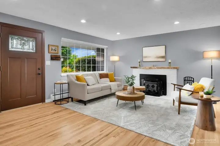 Bright and inviting living room with refinished hardwood floors and abundant natural light in this West Seattle home for sale.