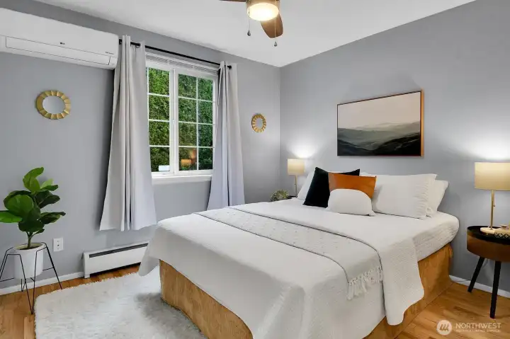 Spacious bedroom retreat with large windows, modern styling, and comfortable layout in walkable West Seattle neighborhood.