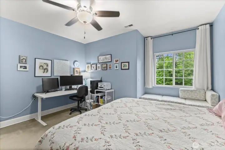 Built-in window seat enhances the comfort and charm of the upper-level bedroom