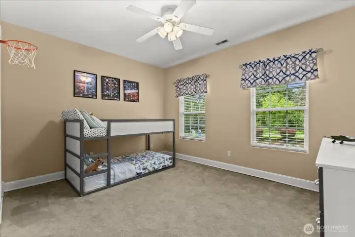 Spacious upstairs bedroom with overhead fan for added airflow