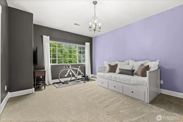 Charming upstairs bedroom showcasing a beautiful decorative chandelier