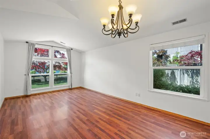 Living and Dining room features vaulted ceiling and many windows.