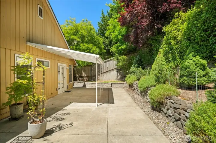 Extended concrete patio for easy yard maintenance.