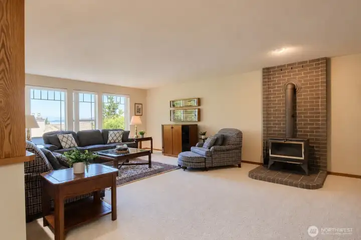 Spacious Family room with large windows & wood stove