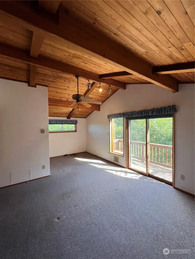 Primary Bedroom also has ceiling fan and sliding glass doors out to the private deck.