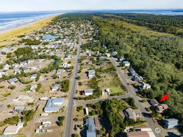 This is the view of the Pacific Ocean merging with Willapa Bay. The home is noted by the red arrow. Life is good at the beach.