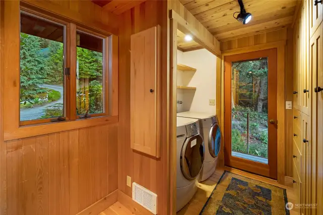 The pantry/laundry room and side entrance with storage. Accessible from the kitchen and main entrance as well.