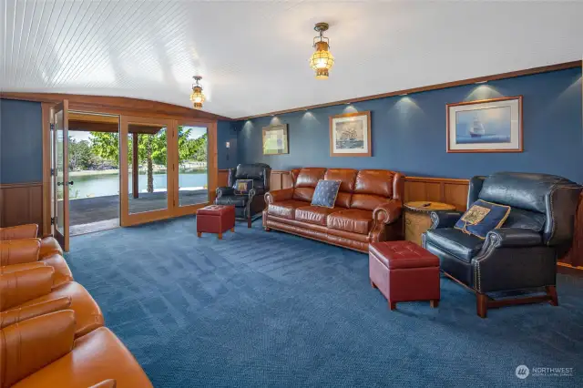 The stately family room has been beautifully finished to resemble a ship's cabin with barrel vaulted ceiling and recessed lighting. French doors lead to the covered patio.