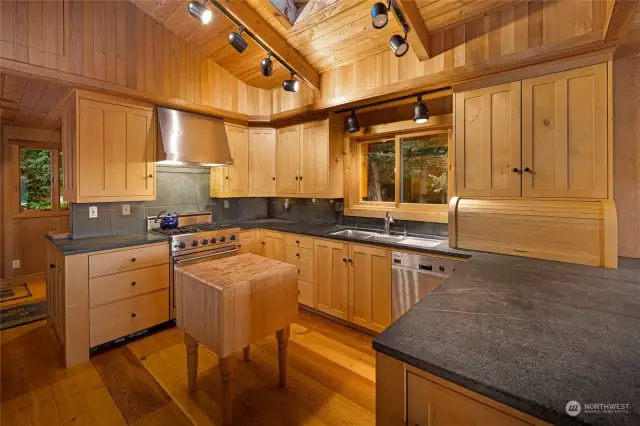 Kitchen with Viking range, soap stone counters, side-by-side subzero refrigerator,  built-in wine coolers. Entrance to pantry/laundry room in the back left.