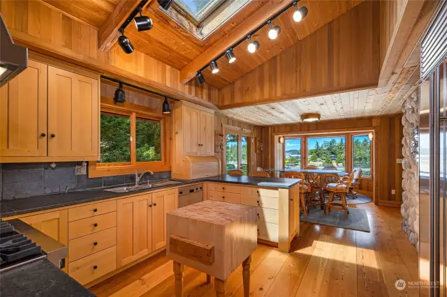 Another view of the kitchen towards the breakfast bar and dining area.