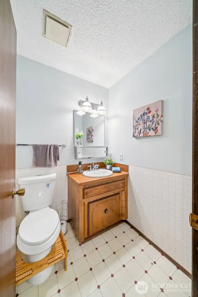 The half bath off the family/bonus space is convenient to the busy activity of the space and the garage and patio entrance from outdoors.