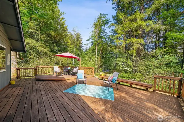 The large deck at the SE end of the home enjoys sunlight and shade at different times of the day.  Loads of space for outdoor entertaining and benches to hold guests or your container garden pots.