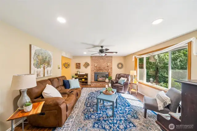 At the entry hall the large living space sits to the right with cozy gas fireplace and hearth, upgraded vinyl windows, and dinning/flex access to left of fireplace. Ceiling fansare found throughout the home!