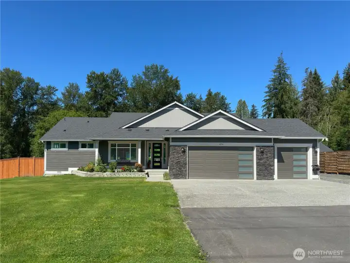Long private driveway with RV parking plus 3 car garage