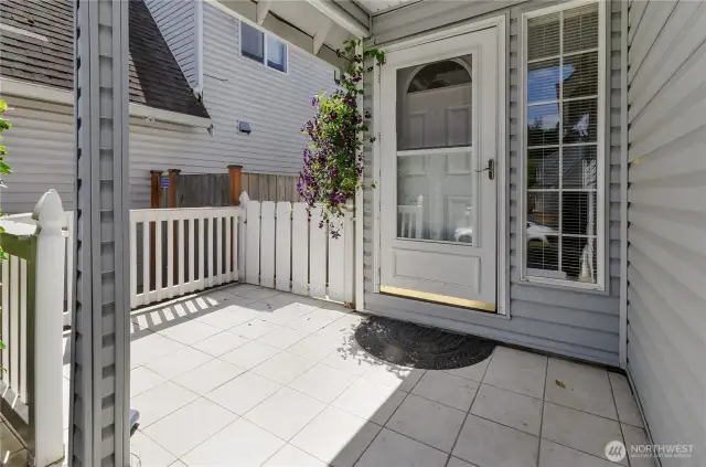 Tile front porch lightens up the east side of the entry to your home!