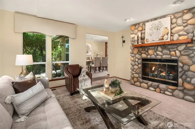 Living room boasts a beautiful river rock fireplace to radiate warmth on chilly nights.
