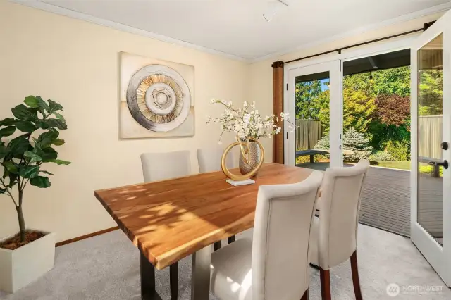 A large dining room opens to your adjoining wooden deck through French doors.