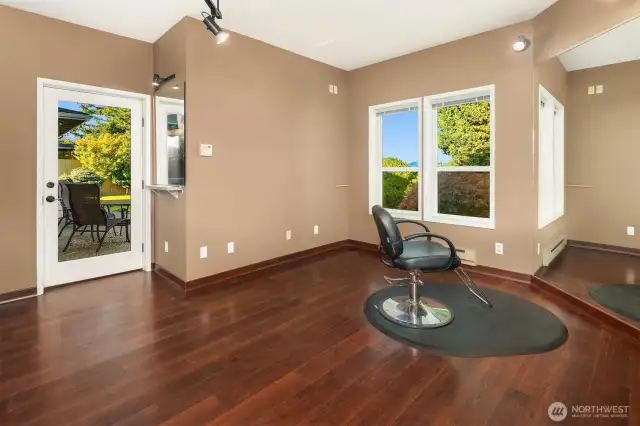 A generous separate area with private entry was a hair salon space, but would be perfectly positioned for a large private office, studio, or guest suite.