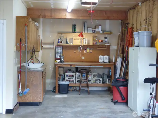 Great 11' x 10' 6" work shop area at the back of the garage.  Includes work bench and cabinets for storage and good lighting.