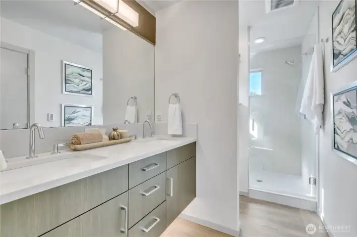 Primary bath with 3-cm quartz countertops, dual lavs, under-cabinet lighting, large shower, and heated floors