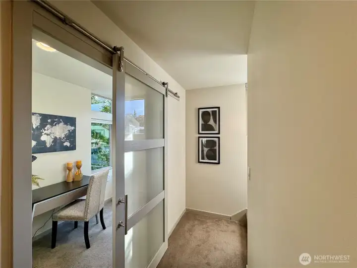 Sliding barn door leads to a versatile space for guests, office or exercise