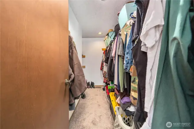 Generous walk-in closet offering organized storage and easy access to wardrobe essentials.