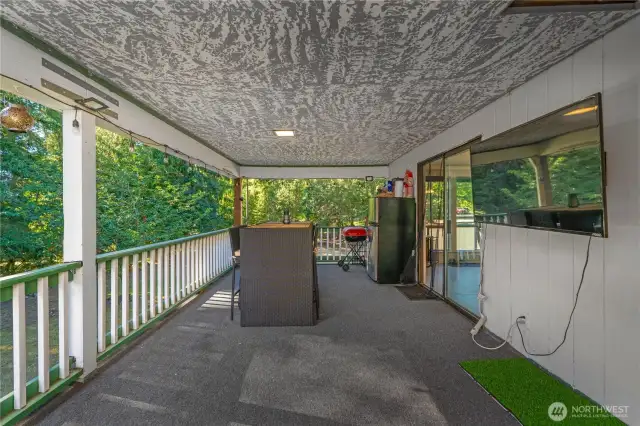 Spacious covered porch area offering plenty of room to design your ideal outdoor dining or lounge setup. This inviting space is perfect for entertaining guests, enjoying fresh air meals, or relaxing while surrounded by the beauty of the outdoors.