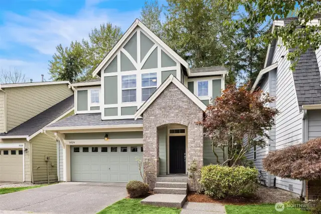 A front of the home boasts a covered front porch, spacious driveway and two car garage.