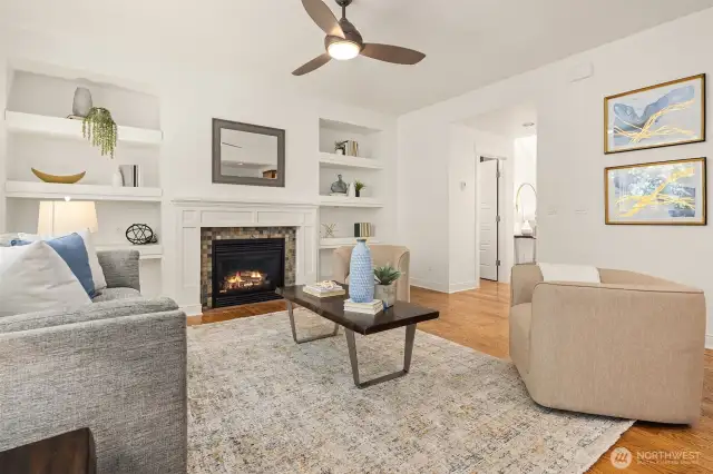 Living space with fireplace and built in shelving. (fire added for effect, buyer to verify funtionality)