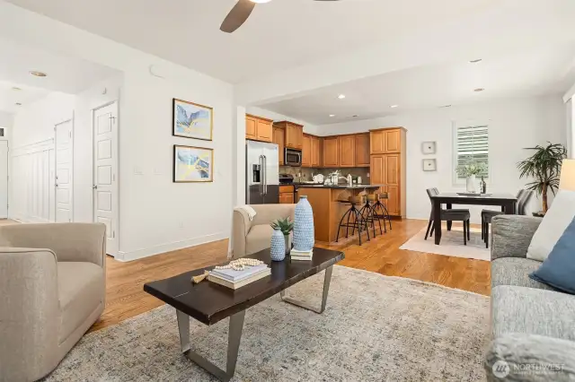 Living room flowing seamlessly into kitchen and dining area.