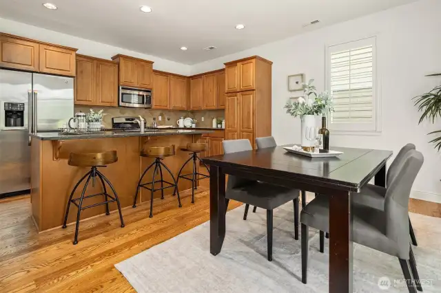 Open concept flow between kitchen and dining room.