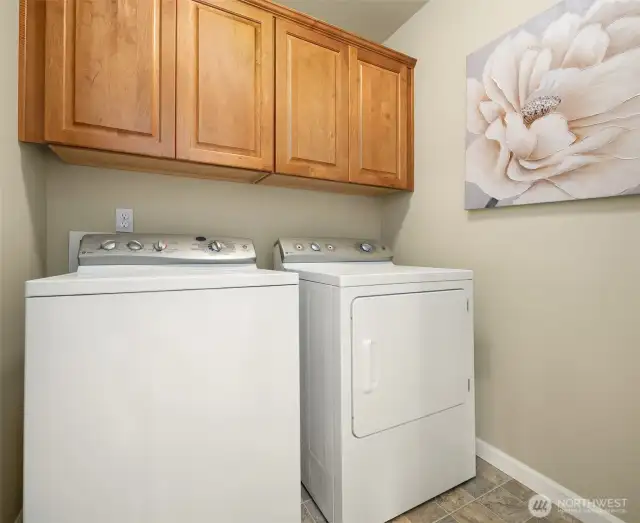 Laundry room with cabinet storage.