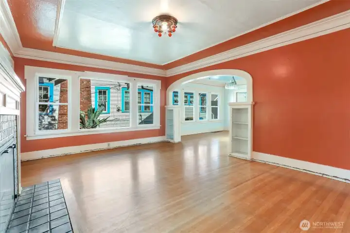 2 bedrooms & 1 bathroom on the main floor & showcases oak floors, foyer, coved ceilings, fireplace, picture molding & a period archway connecting the living & dining rooms.