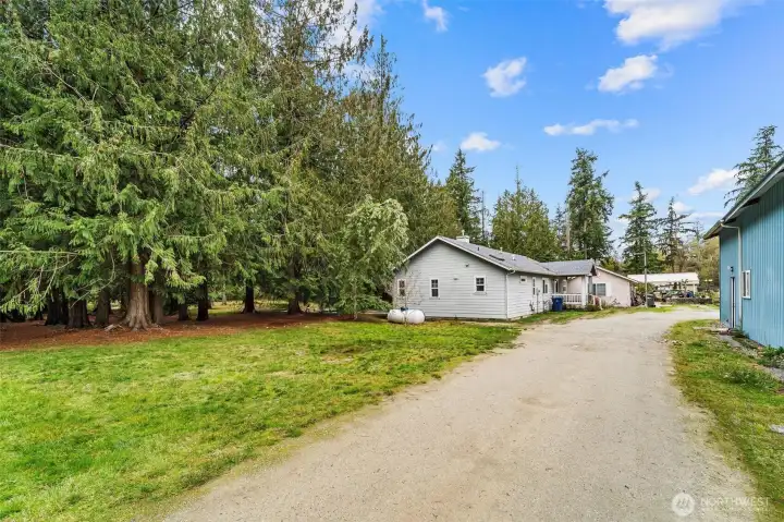 Gravel entrance to duplex, next to shop