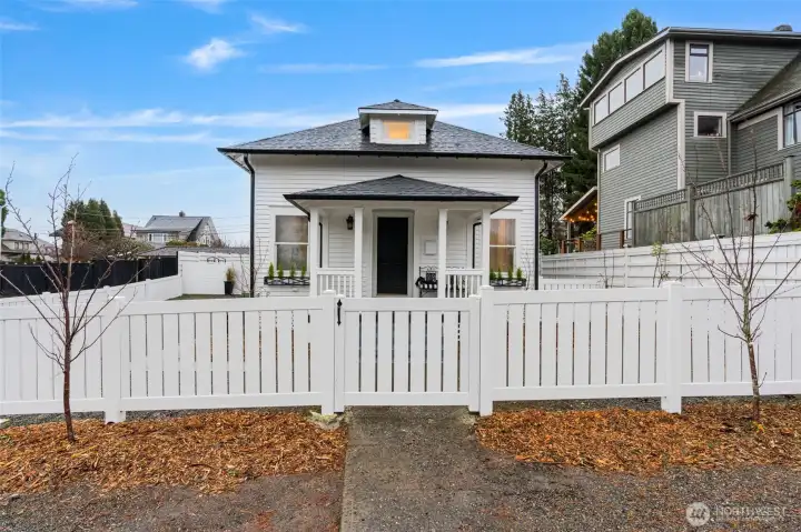 Gated and fenced front and back yards, featuring fruit trees and abundant garden space.