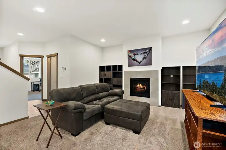 The living room features a cozy fireplace.