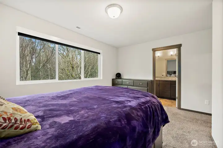 The Primary Suite also features that peaceful view towards the greenbelt.