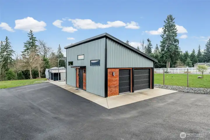 Look at this detached 4 car garage/shop and currently a partial party cave! Small kitchenette, heat and TV for so much fun!  There is a carport on the other side!