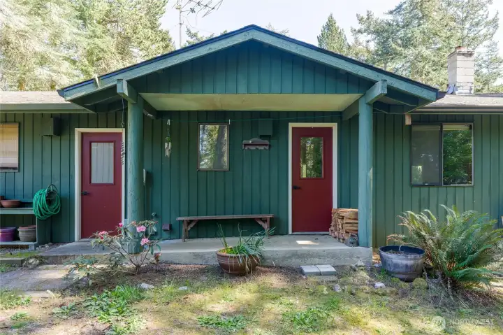 Red doors lead to garage left, house right
