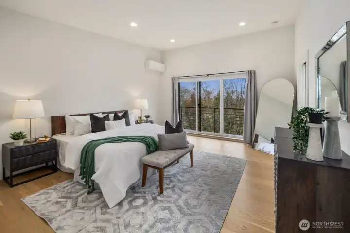 Spacious primary suite with Olympic Range views and private deck