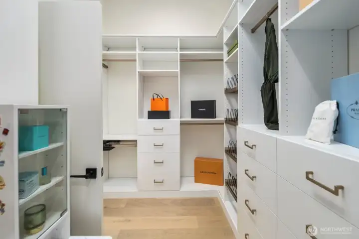 Primary walk-in closet with custom built-ins