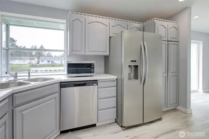 Updated kitchen with modern finishes, cabinets, and stainless steel appliances.
