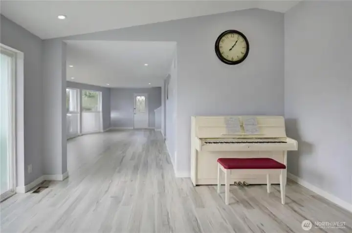 Bright and spacious main floor living area featuring updated flooring, soft neutral finishes, and an open, flowing layout